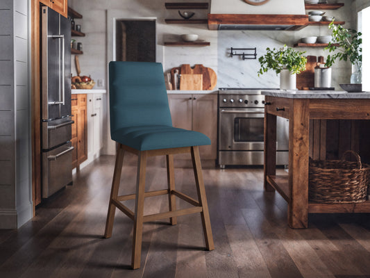 Blue channel tufted bar stools with black metal legs, featuring plush velvet upholstery and a modern design. Perfect for kitchen islands or home bars, combining comfort and style.