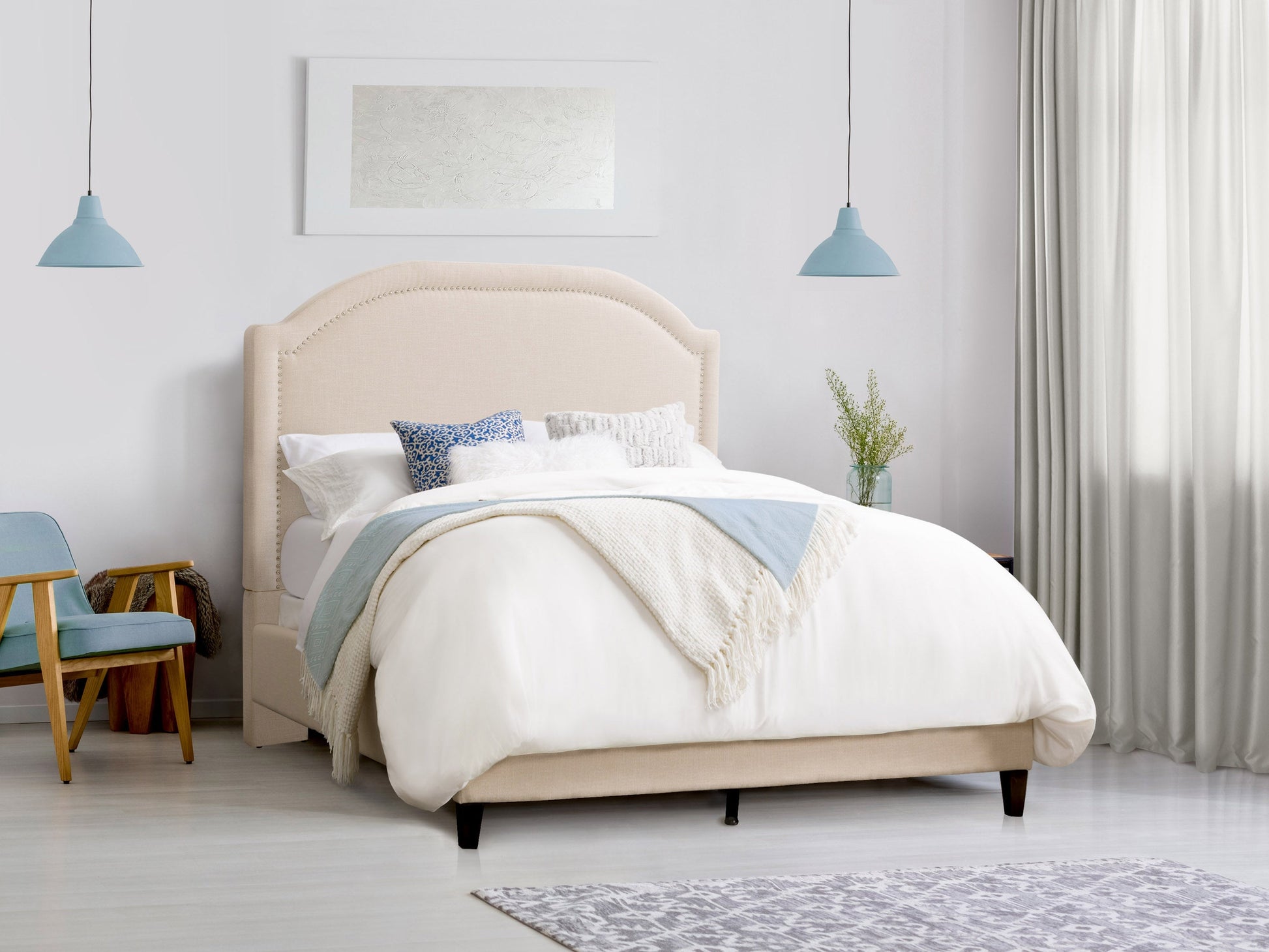 Cream upholstered king bed with tufted headboard, soft fabric, wooden legs, and a sturdy frame. Ideal for modern and classic bedrooms.