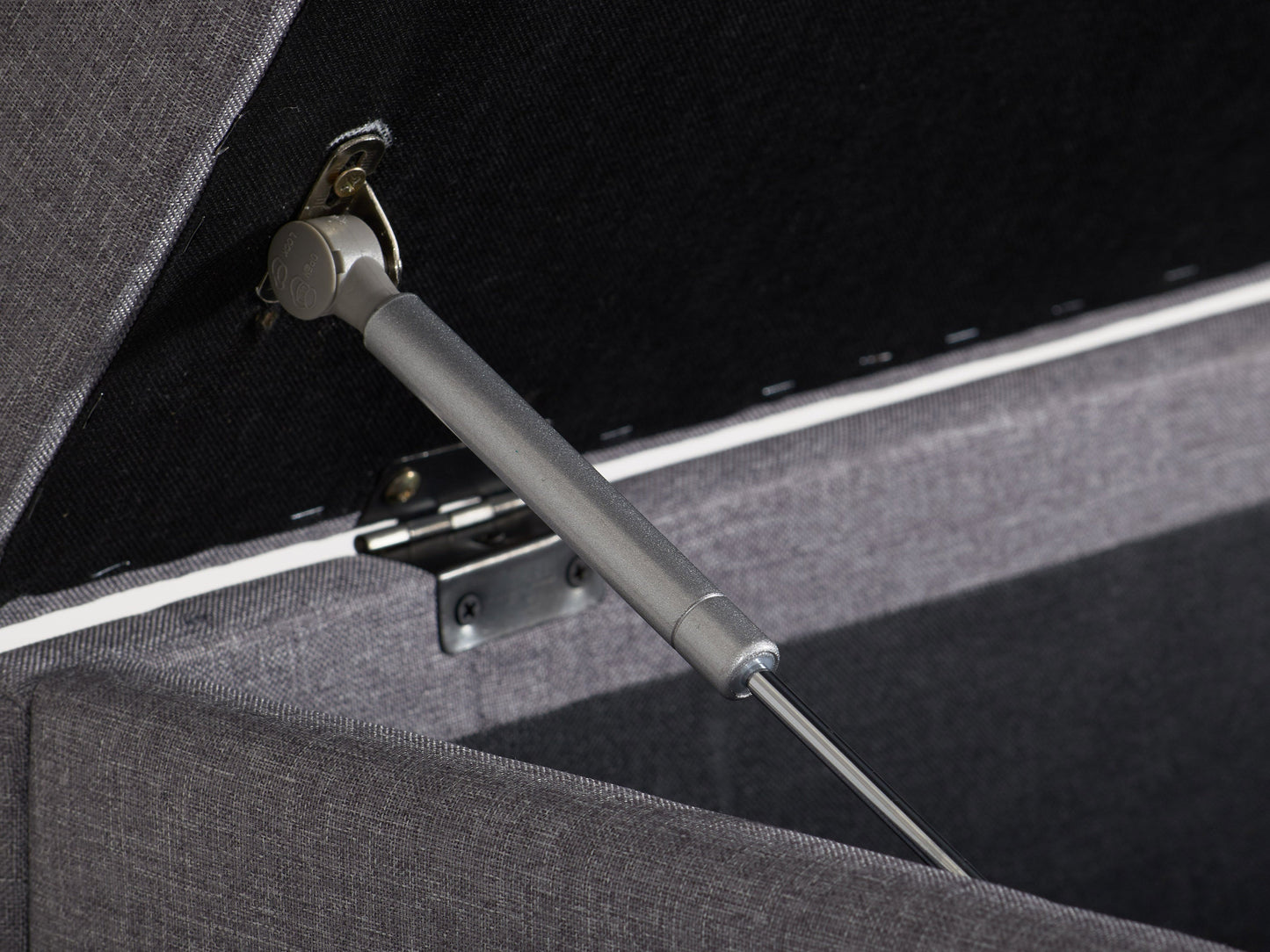 Light grey large storage ottoman with tufted top, soft fabric upholstery, and wooden legs. Ideal for living rooms or bedrooms, providing extra seating and hidden storage space.