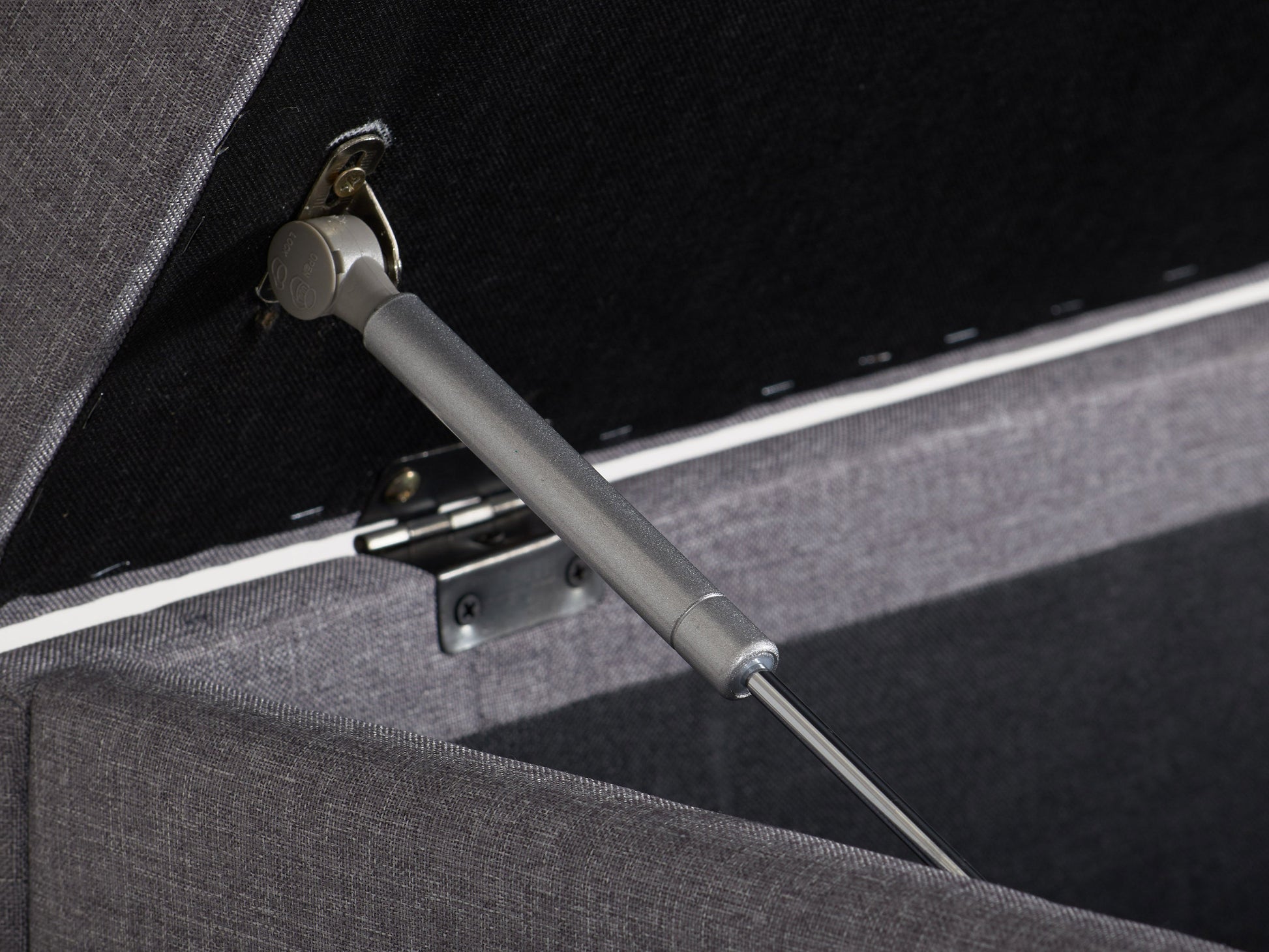 Light grey large storage ottoman with tufted top, soft fabric upholstery, and wooden legs. Ideal for living rooms or bedrooms, providing extra seating and hidden storage space.