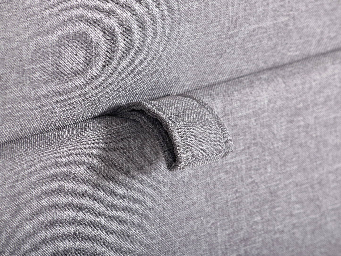 Light grey large storage ottoman with tufted top, soft fabric upholstery, and wooden legs. Ideal for living rooms or bedrooms, providing extra seating and hidden storage space.