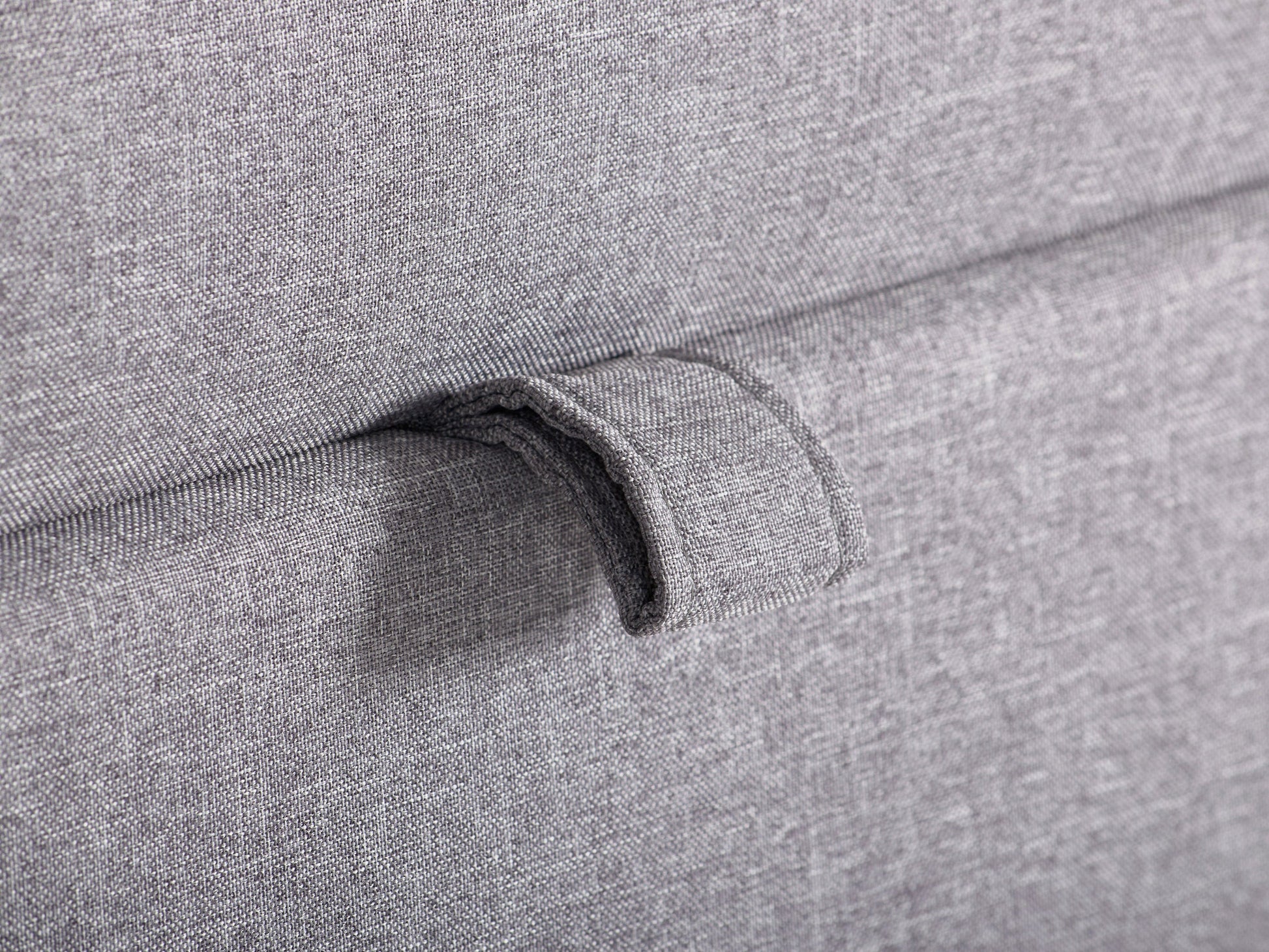 Light grey large storage ottoman with tufted top, soft fabric upholstery, and wooden legs. Ideal for living rooms or bedrooms, providing extra seating and hidden storage space.