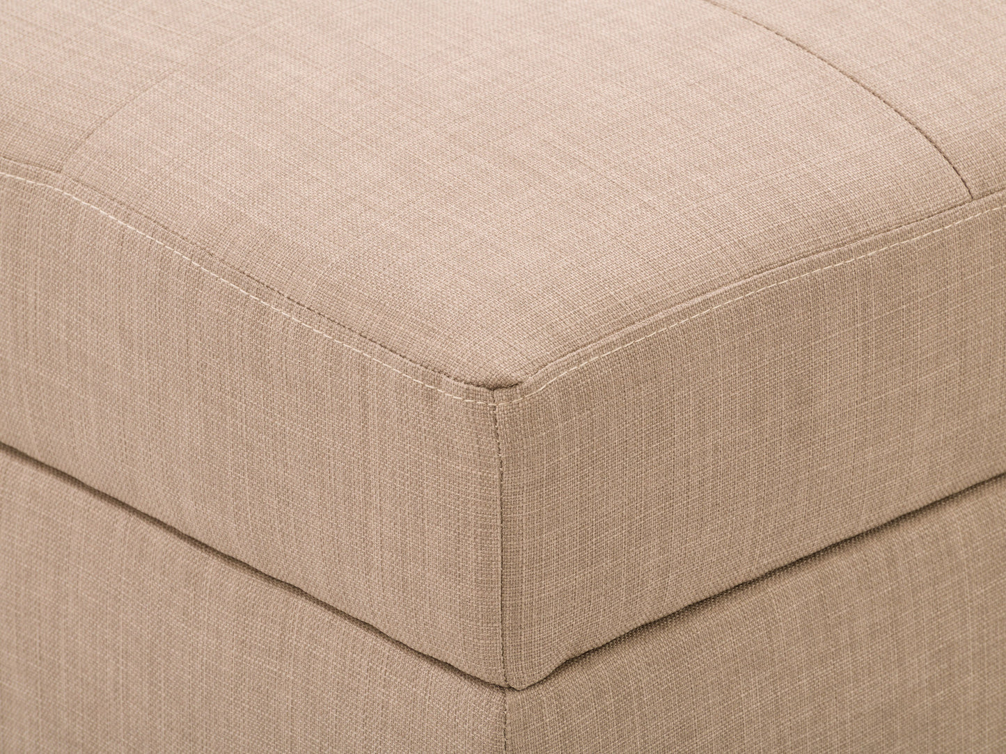 Tufted storage ottoman in light grey fabric with button-tufted top, wooden legs in dark finish, and hidden compartment for storage. Ideal for living room seating and organization.