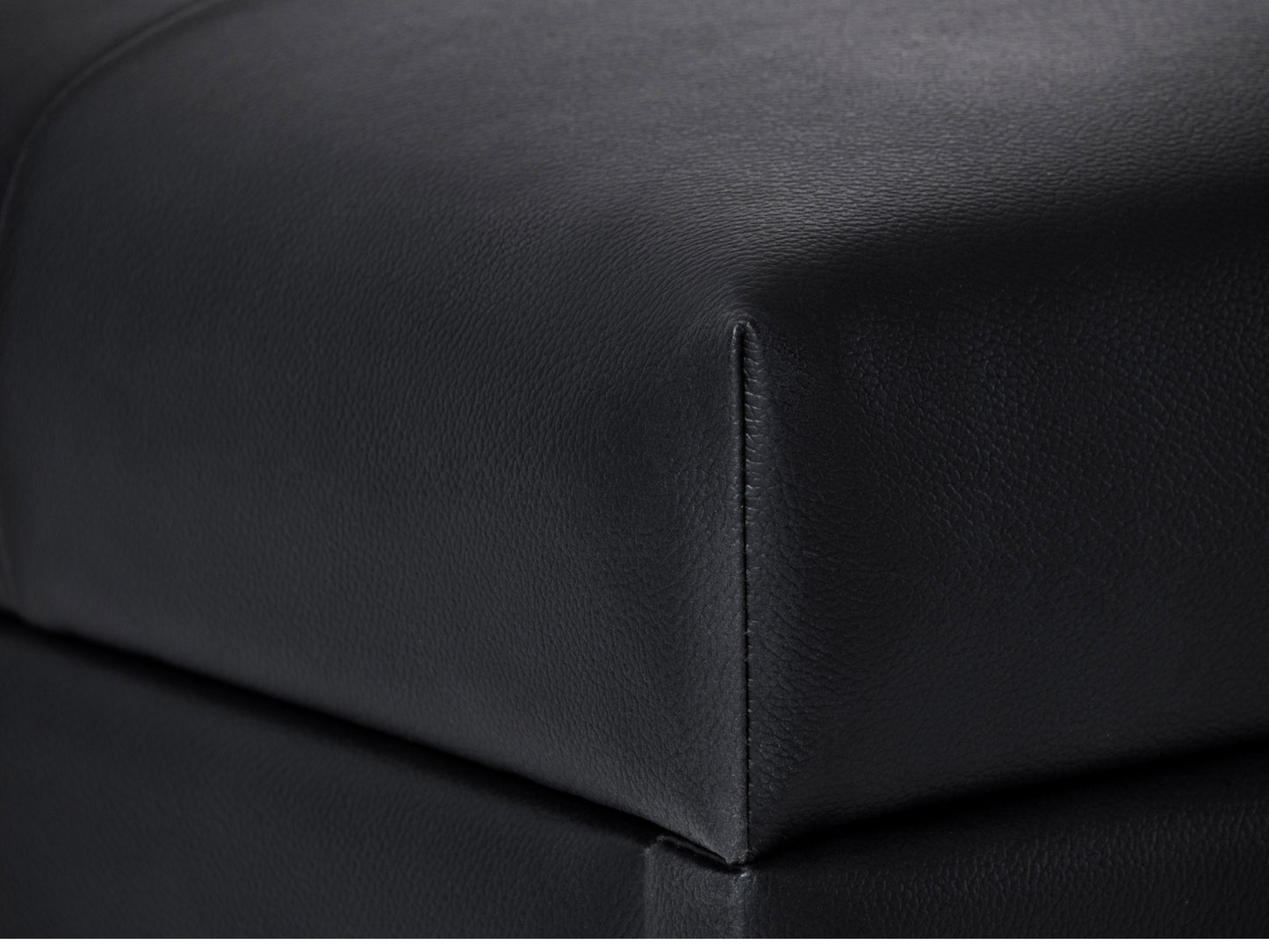 Brown vegan leather storage ottoman with tufted top, wooden legs, and spacious interior storage compartment.