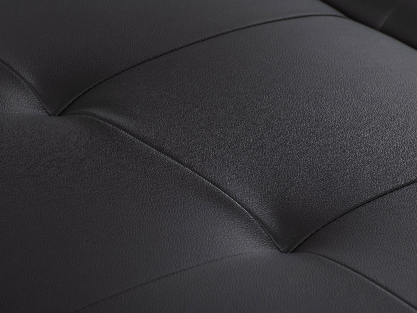 Matte black deluxe storage ottoman with tufted faux leather upholstery, spacious interior storage, and sleek minimalist design. Ideal for modern living rooms and versatile as extra seating or a coffee table.