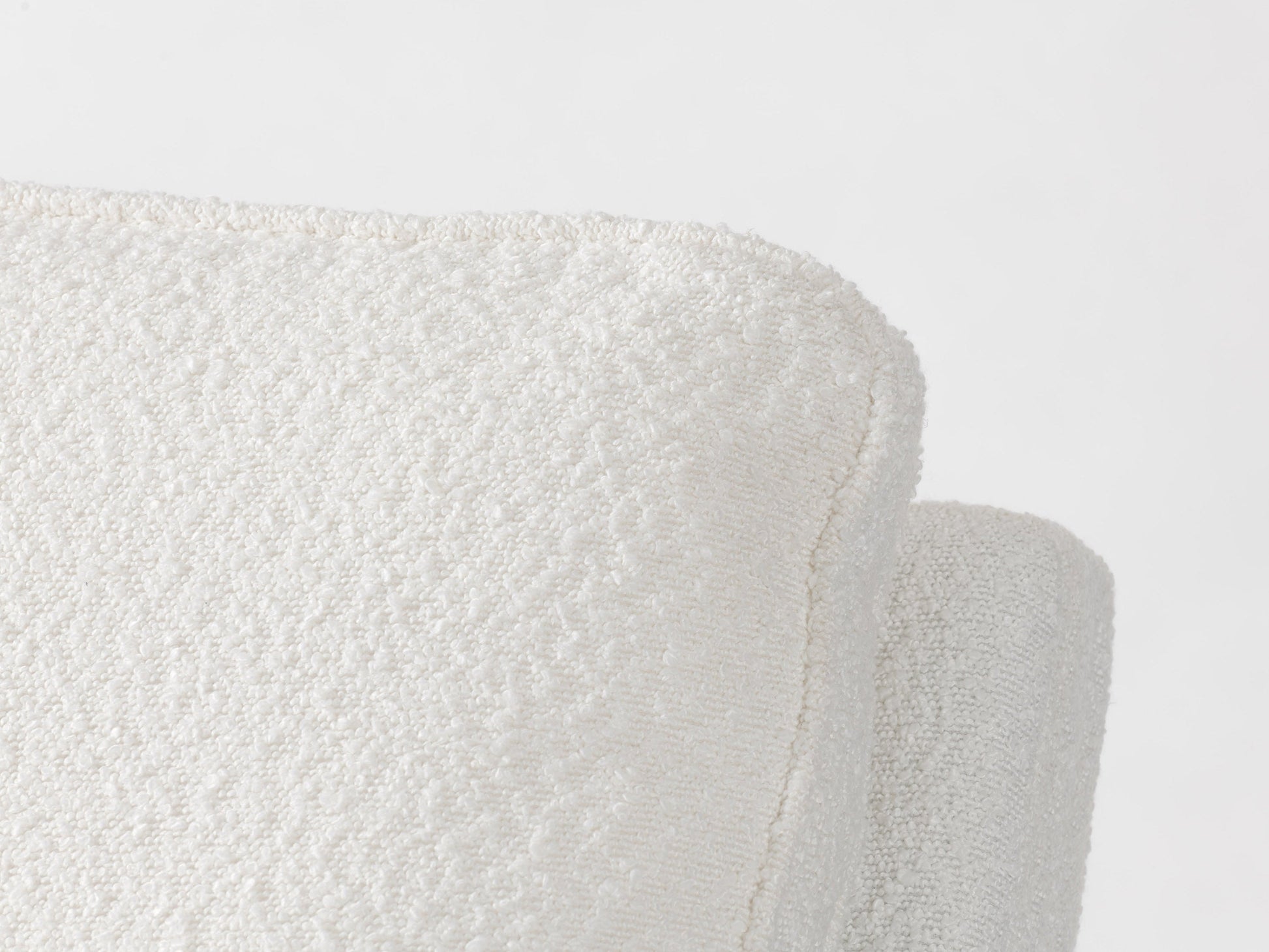 Cream boucle swivel recliner chair with plush texture, ergonomic design, and sleek metal base, perfect for modern living rooms or cozy reading nooks.