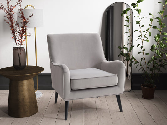 Elegant grey velvet accent chair with plush cushioning, sleek gold metal legs, and tufted backrest. Ideal for modern living rooms or offices, this stylish chair offers both comfort and sophistication.
