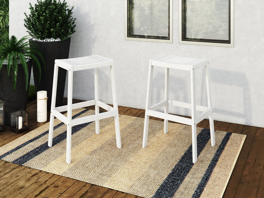 Set of 2 natural wood patio bar stools in washed white finish with slatted backrests and contoured seats for outdoor use.