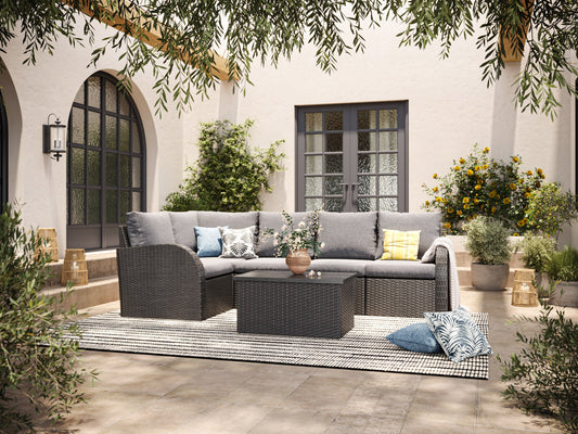 Grey outdoor sectional middle piece patio chair with weather-resistant wicker, plush grey cushions, and aluminum frame, ideal for modern outdoor seating arrangements.