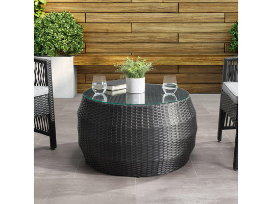 Round wicker patio coffee table with glass top, featuring a natural woven texture and sturdy aluminum frame, perfect for outdoor seating areas.