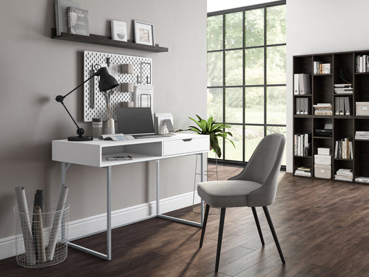 Modern white computer desk with sleek metal legs, spacious tabletop, built-in cable management, and minimalist design. Ideal for home office or study.