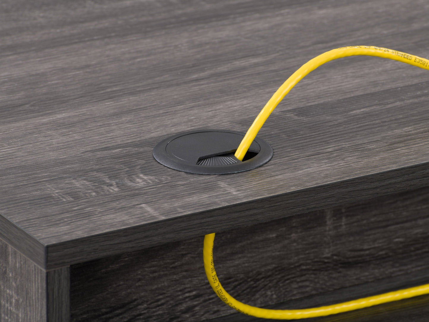 Sleek modern computer desk in grey with a smooth laminate surface, sturdy metal frame, and built-in cable management, ideal for home offices or workspaces.