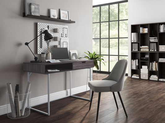 Sleek modern computer desk in grey with a smooth laminate surface, sturdy metal frame, and built-in cable management, ideal for home offices or workspaces.
