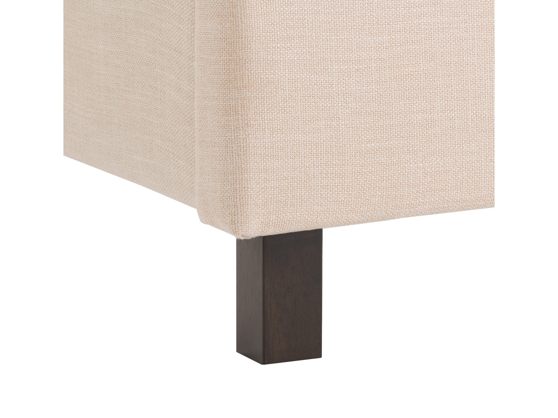 Tufted twin bed with beige linen upholstery, dark wooden legs, and button-tufted headboard featuring diamond stitching detail.