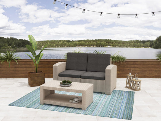 Outdoor wicker loveseat in dark brown with beige cushions, featuring a sturdy rattan frame and weather-resistant fabric, perfect for patio conversation sets.