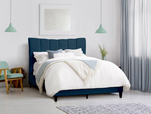 Navy blue channel tufted double/full bed with plush velvet upholstery, sleek modern design, and sturdy wooden legs. Perfect for adding a touch of elegance and comfort to any bedroom decor.