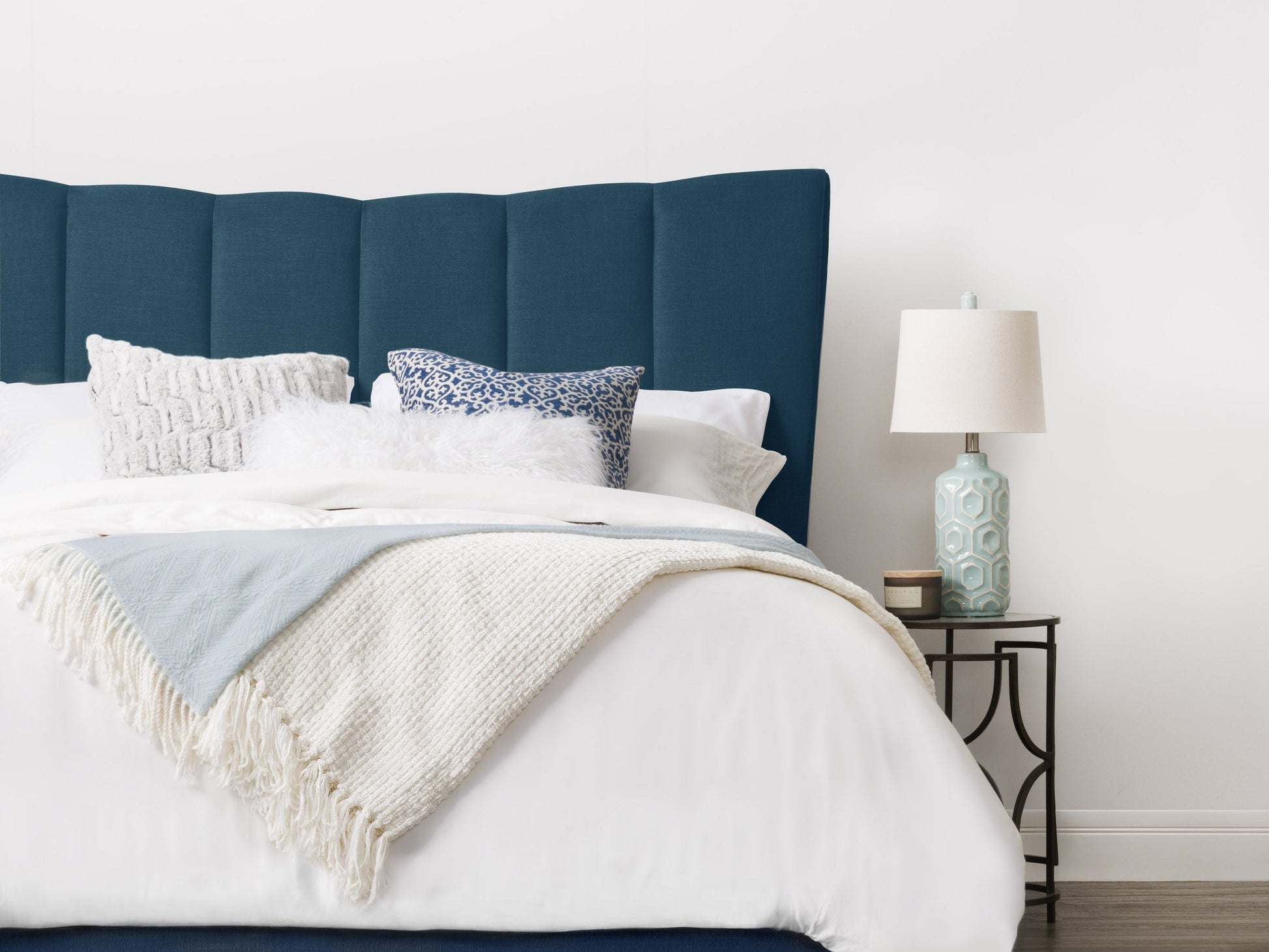 Navy blue channel tufted double/full bed with plush velvet upholstery, sleek modern design, and sturdy wooden legs. Perfect for adding a touch of elegance and comfort to any bedroom decor.