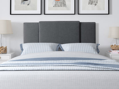Dark grey adjustable headboard with tufted upholstery, sleek design, and soft fabric texture, suitable for queen and king size beds. Ideal for modern bedroom decor, offering customizable height settings.
