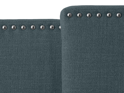 Blue adjustable headboard with tufted fabric, soft texture, and sleek design, perfect for modern bedrooms.