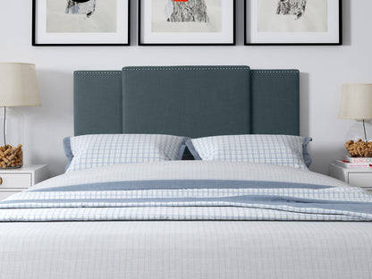 Blue adjustable headboard with tufted fabric, soft texture, and sleek design, perfect for modern bedrooms.