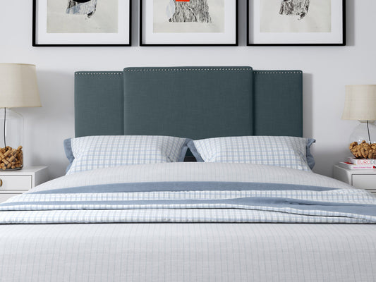 Blue adjustable headboard with tufted fabric, soft texture, and sleek design, perfect for modern bedrooms.