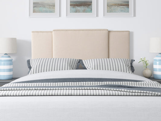 Cream adjustable headboard with tufted fabric, soft padding, and sleek design, compatible with various bed frames, ideal for modern or classic bedroom decor.