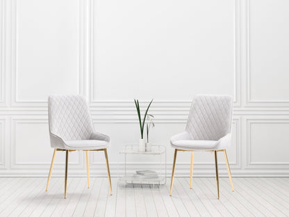 Light grey velvet dining chairs, set of 2, with tufted backrest, gold metal legs, and contemporary design. Perfect for modern dining rooms or kitchens. Luxurious and elegant seating solution.