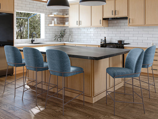 Blue modern bar stool with sleek metal legs, cushioned seat, and backrest. Features a minimalist design with a contemporary look, perfect for kitchen islands or home bars.