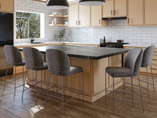 Dark grey modern bar stool with sleek metal legs, cushioned seat, and curved backrest; ideal for contemporary kitchen or bar settings.