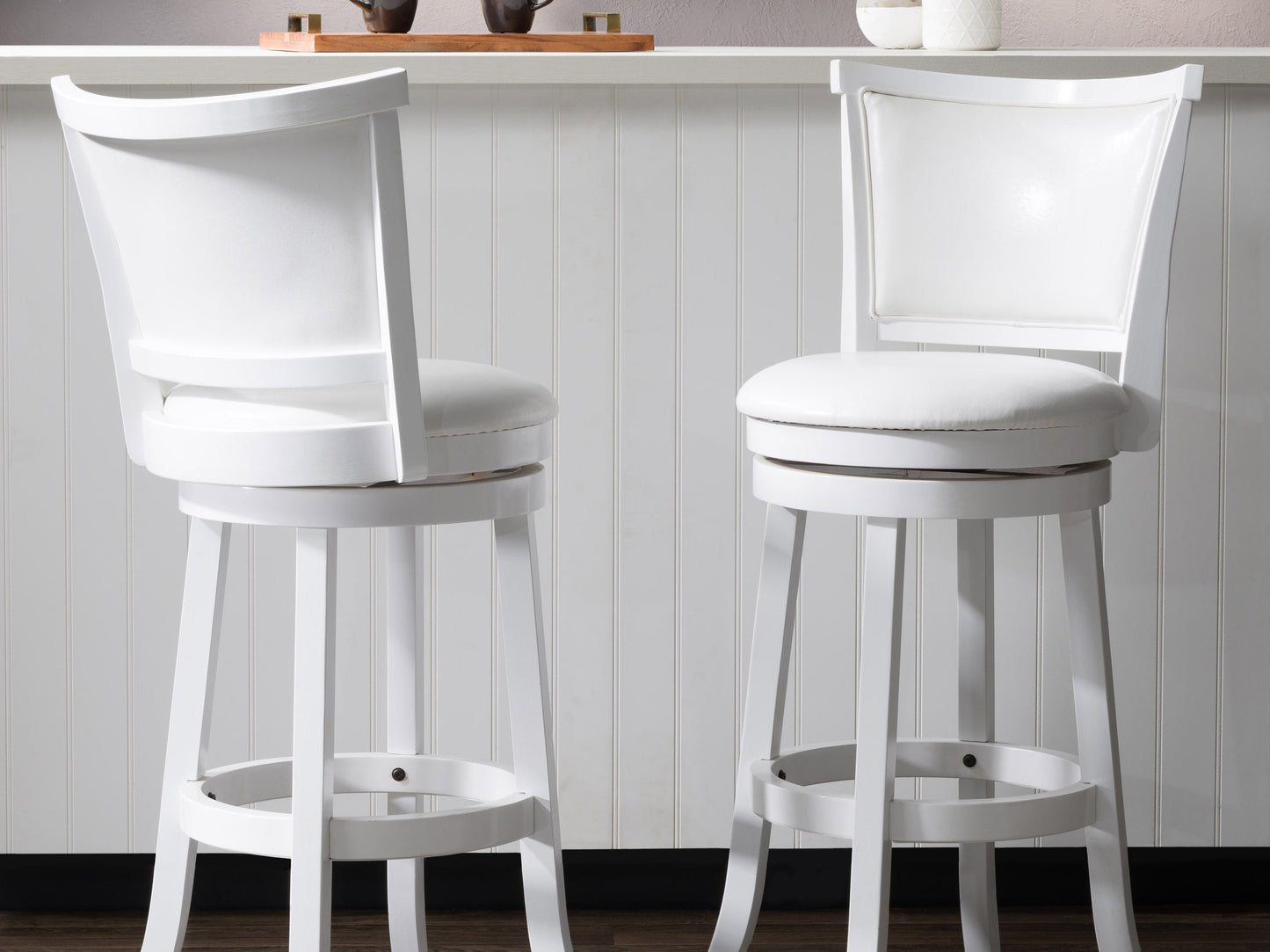 White bar height bar stools set of 2, featuring sleek chrome legs, cushioned seats with white faux leather upholstery, and footrests for added comfort, perfect for modern kitchen or bar settings.