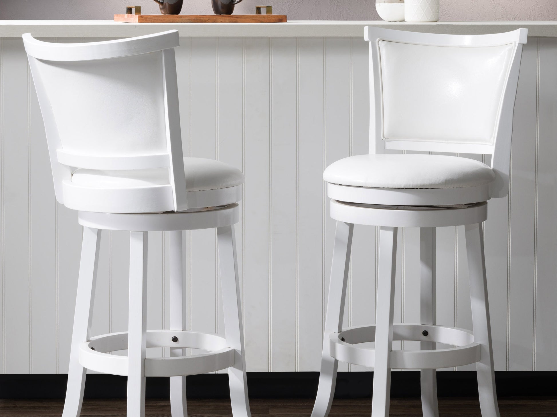 White bar height bar stools set of 2, featuring sleek chrome legs, cushioned seats with white faux leather upholstery, and footrests for added comfort, perfect for modern kitchen or bar settings.