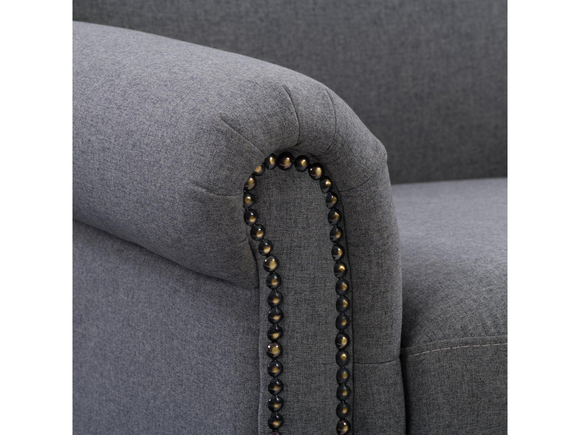 Grey armchair with plush upholstery, sleek wooden legs, and tufted backrest. The chair features a modern design with comfortable armrests, perfect for living rooms or offices.