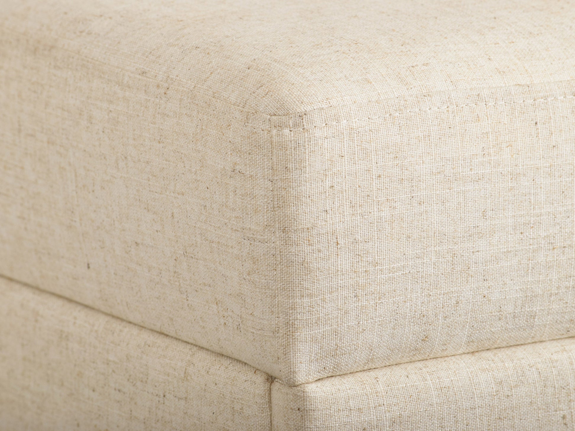 Beige large storage ottoman with tufted top, linen fabric, wooden legs, and spacious interior compartment for extra storage.