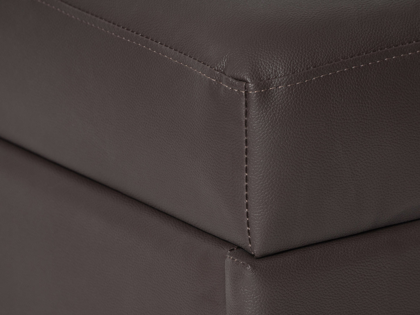 Brown vegan leather storage ottoman with tufted top, rectangular shape, and hidden storage compartment. Ideal for living rooms or bedrooms, offering both style and functionality.