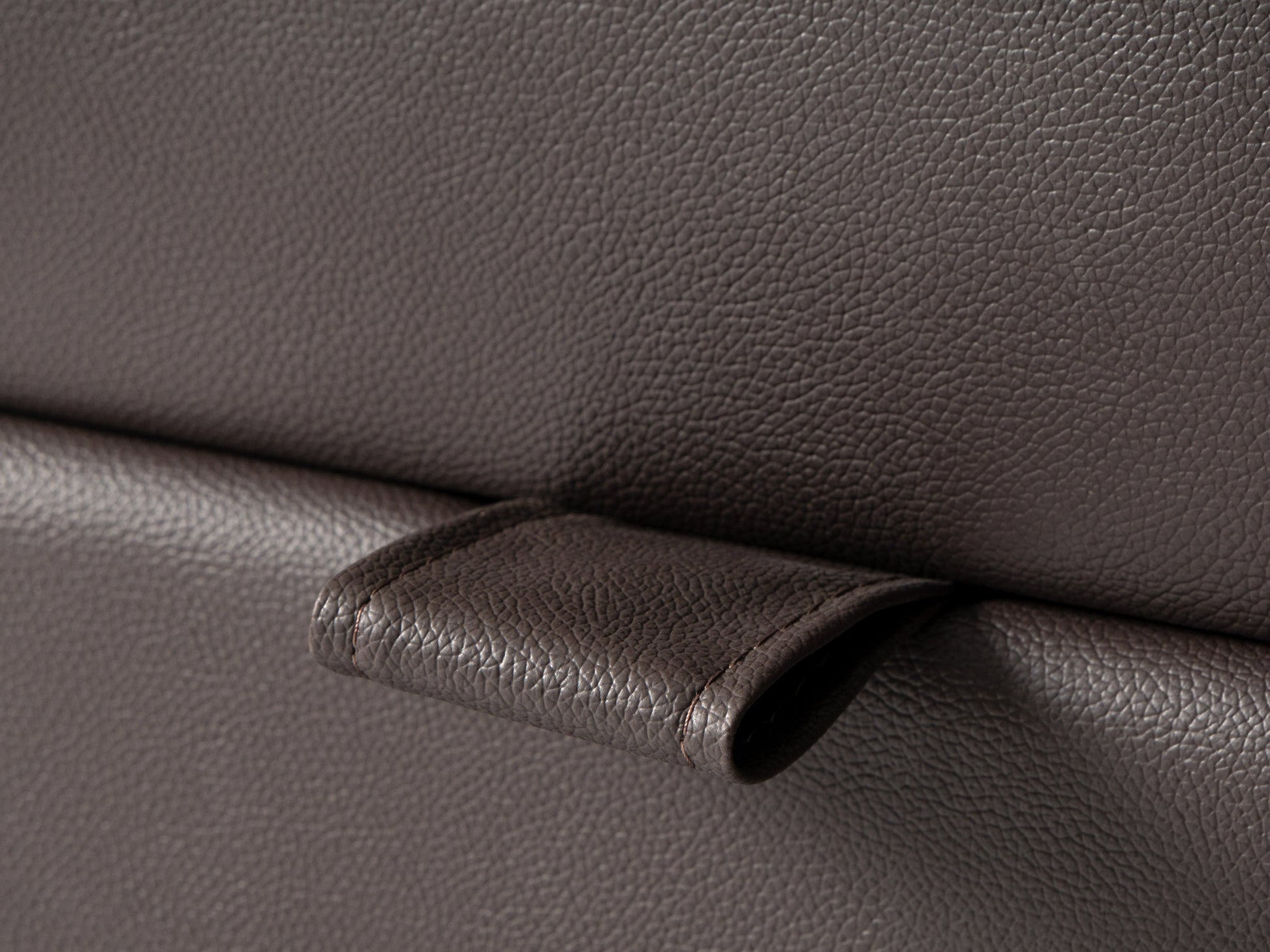 Brown vegan leather storage ottoman with tufted top, rectangular shape, and hidden storage compartment. Ideal for living rooms or bedrooms, offering both style and functionality.