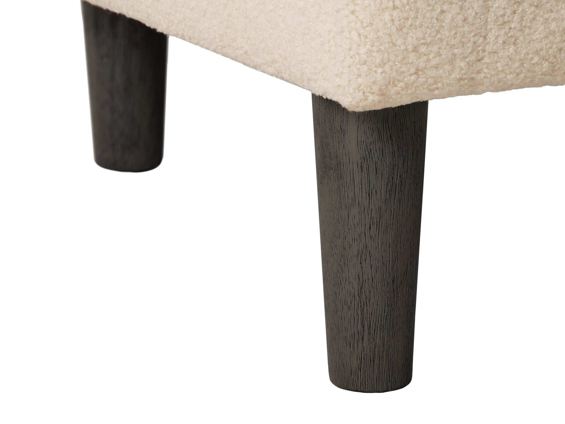 Cream boucle barrel accent chair with curved backrest, plush texture, and wooden legs. Chair features a modern design, perfect for living rooms or reading nooks.