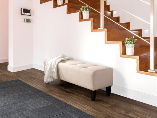 Cream accent bench with tufted upholstery, wooden legs, and a sleek design. The bench features a soft, cream-colored fabric with button detailing and dark wooden legs, perfect for entryways or living rooms.