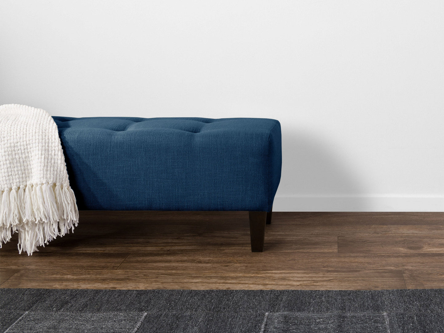 Navy blue accent bench with tufted velvet upholstery, gold metal legs, and a sleek modern design. Perfect for living rooms or entryways, providing both style and comfort.