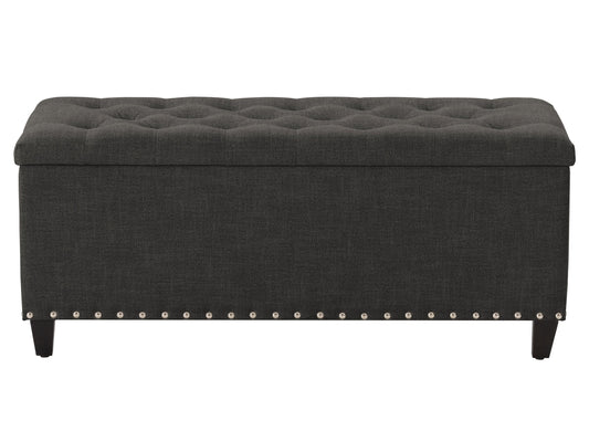 Dark grey tufted storage ottoman with soft fabric, sturdy wooden legs, and spacious interior compartment for storage. Perfect for living rooms or bedrooms, adding both style and functionality.