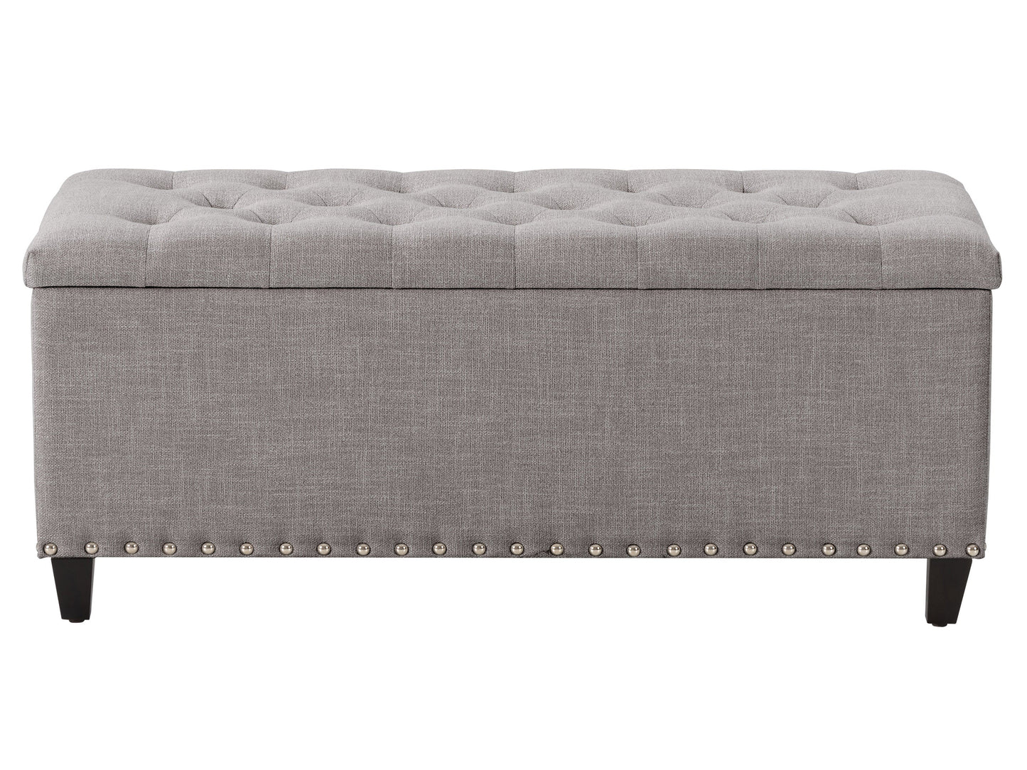 Light grey tufted storage ottoman with soft fabric upholstery, button-tufted top, and dark wooden legs. Features spacious interior storage and versatile design, perfect for living rooms or bedrooms.