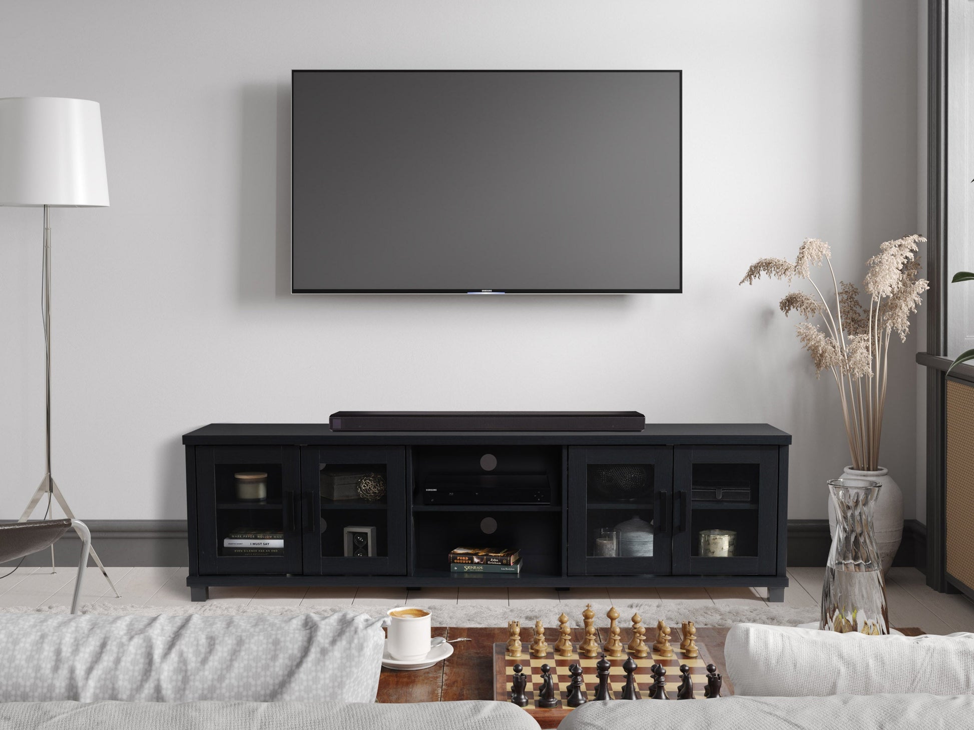 Black TV stand for TVs up to 95 inches, featuring sleek modern design, sturdy wooden material, open shelving for media devices, and cable management system for a clutter-free setup.
