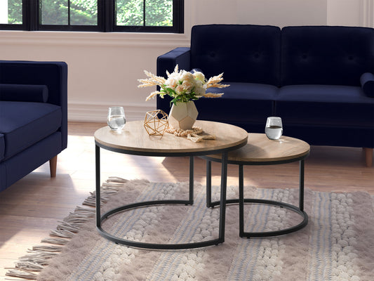 Light wood round nesting coffee tables with a smooth finish, featuring a minimalist design and sturdy metal legs. Ideal for modern living rooms, these space-saving tables can be used together or separately.