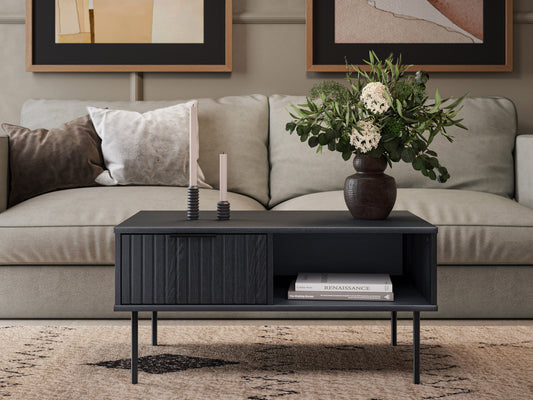 Black fluted coffee table with sleek round design, made of durable wood, featuring a textured fluted base and smooth top surface, perfect for modern living rooms or minimalist decor.
