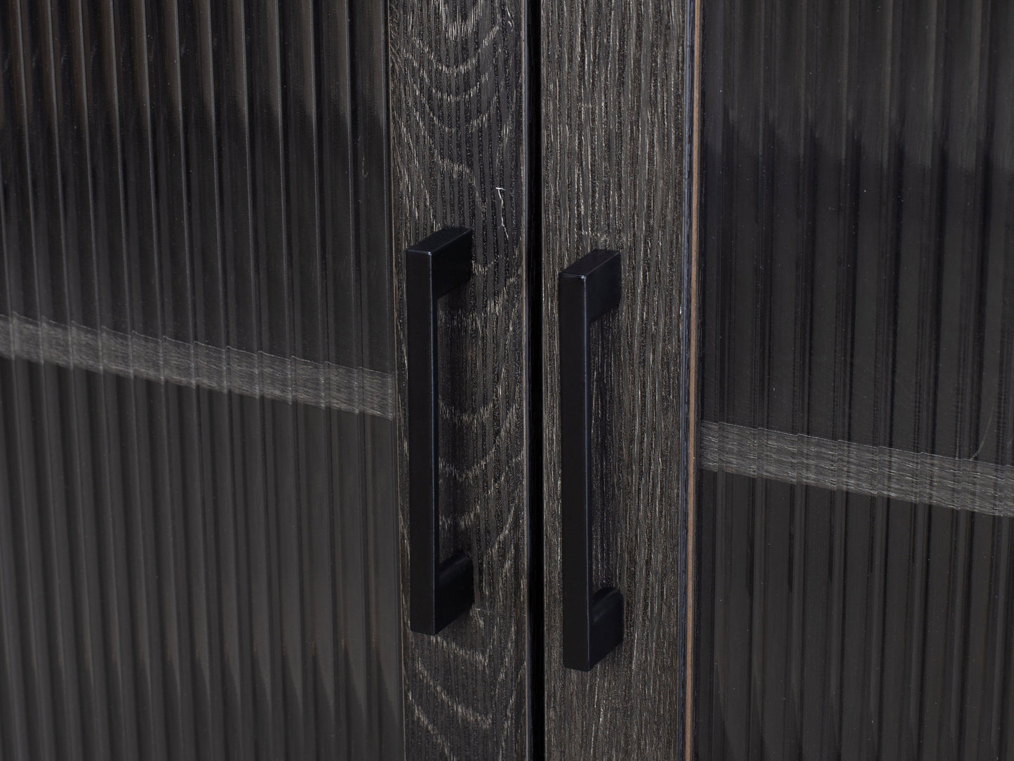 Fluted glass buffet cabinet with black metal frame, light wood finish, and textured glass doors featuring vertical ribbed patterns. Elegant dining storage solution with modern design and ample space for dishware.