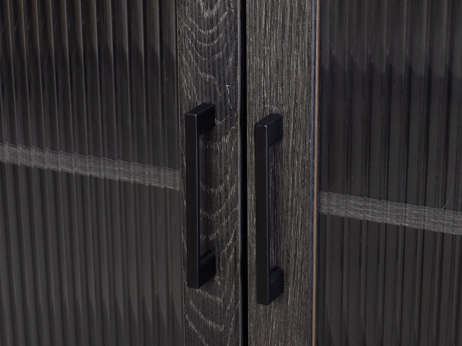 Fluted glass buffet cabinet with black metal frame, light wood finish, and textured glass doors featuring vertical ribbed patterns. Elegant dining storage solution with modern design and ample space for dishware.