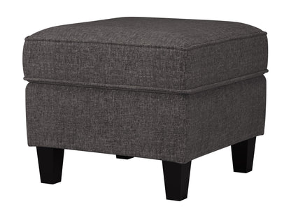 Grey fabric ottoman with tufted top, wooden legs, and soft texture, ideal for living room or bedroom decor.