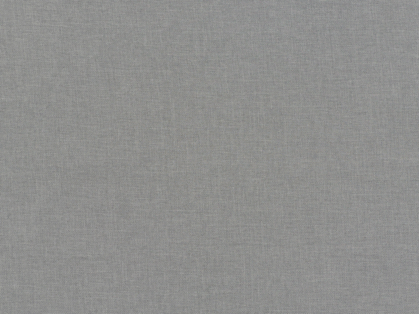Light grey fabric ottoman with tufted top, wooden legs, and soft texture; ideal for living room seating or storage.