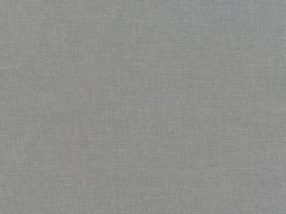 Light grey fabric ottoman with tufted top, wooden legs, and soft texture; ideal for living room seating or storage.