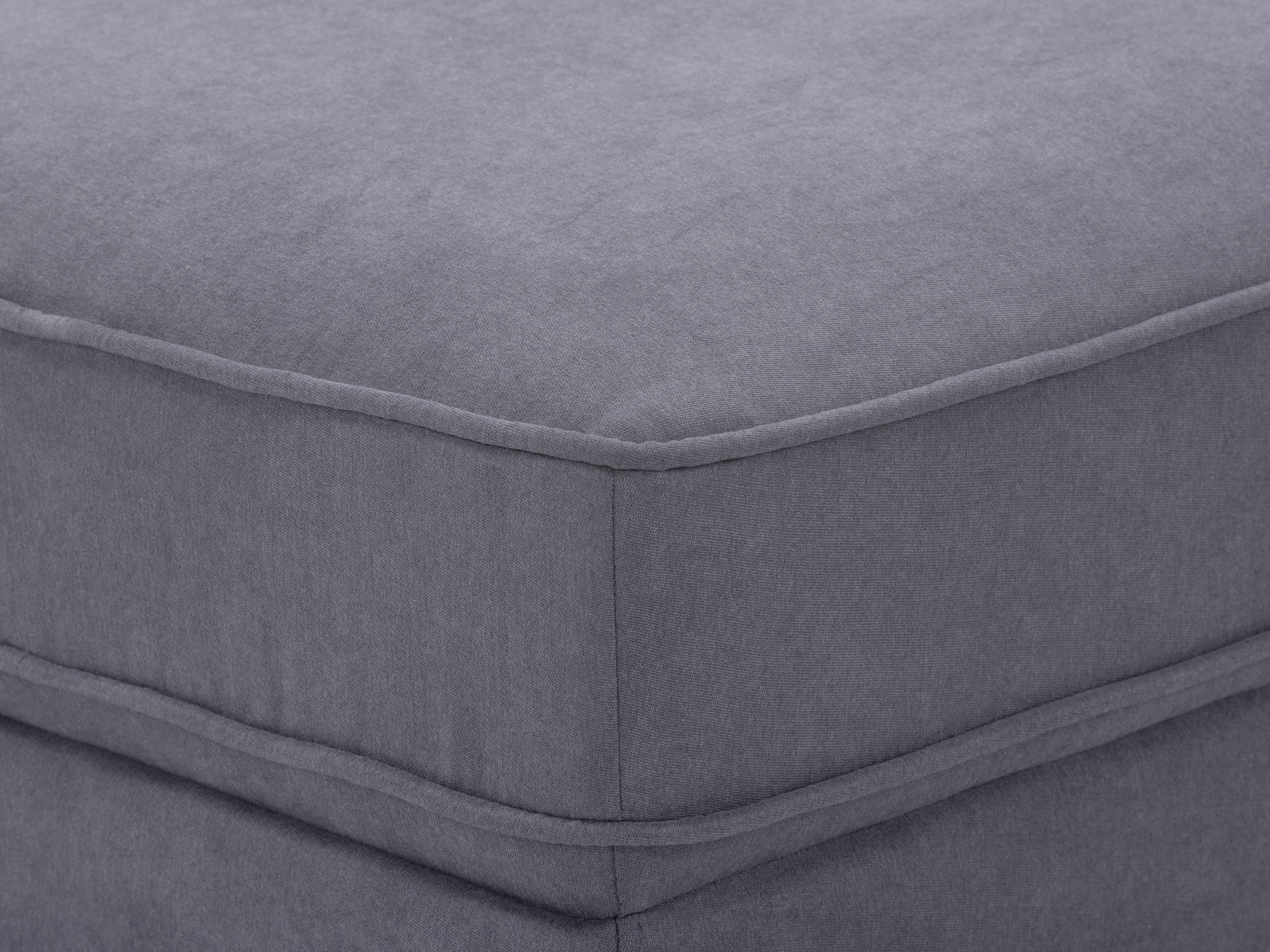 Grey mid-century modern ottoman with wooden legs, upholstered in soft fabric. Features a minimalist design with tufted top cushion and sturdy construction, perfect for living room or office decor.