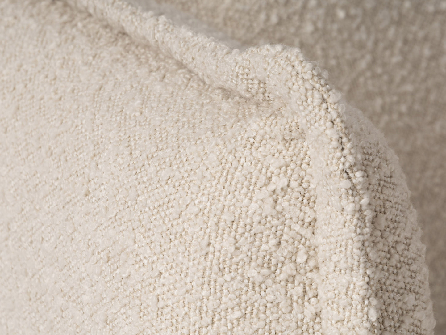 Modern boucle loveseat in cream, featuring soft textured fabric, sleek wooden legs, and plush cushioning for comfort and style, perfect for contemporary living rooms or cozy reading nooks.